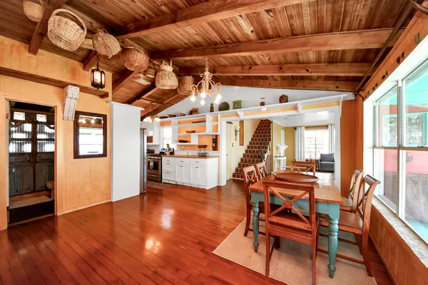 a dining room with a wooden table and chairs