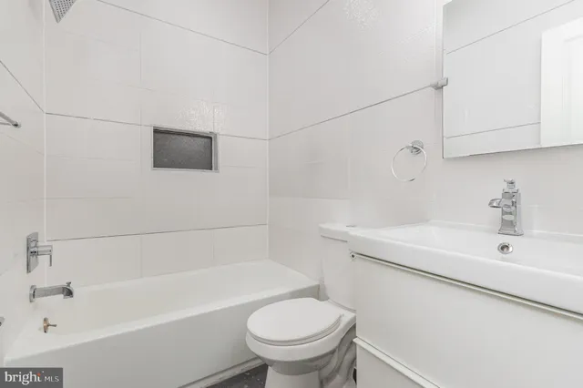 a bathroom with a sink a toilet and bathtub