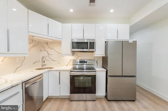 a kitchen with a stove and a refrigerator