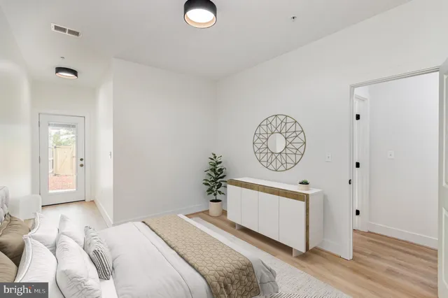 a bedroom with a bed and a clock on the wall