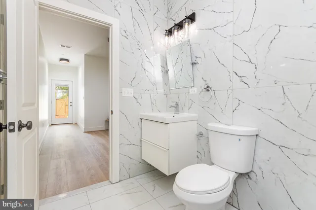 a bathroom with a toilet sink and shower