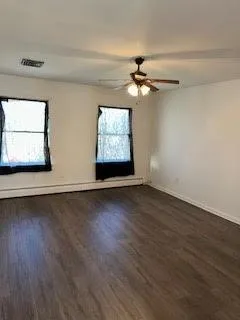 a view of a ceiling fan and wooden floor
