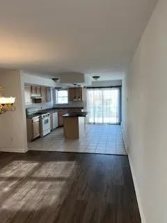 a view of kitchen with microwave and cabinets