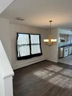 a large kitchen with stainless steel appliances a large counter top a stove a chimney a sink and a large window