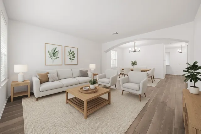 a living room with furniture and a wooden floor