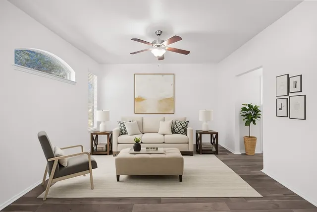 a living room with furniture and a chandelier
