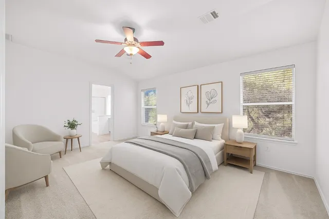 a bedroom with a large bed and a chandelier