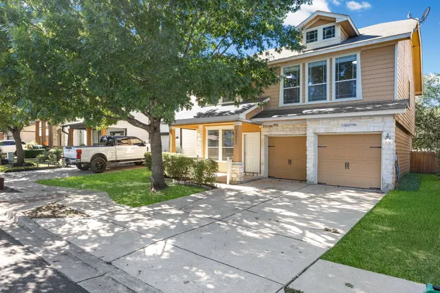 a front view of a house with a yard and garage