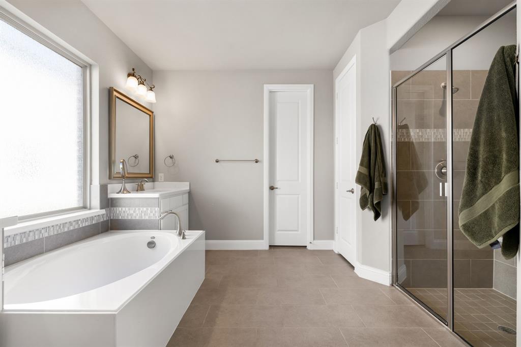6309 Hall Road Frisco, TX 75034 - Photo 16 of 35 Bathroom featuring vanity, a garden tub, a stall shower, and light tile patterned floors