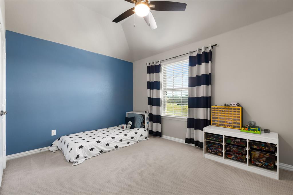 6309 Hall Road Frisco, TX 75034 - Photo 22 of 35 Bedroom featuring carpet flooring, vaulted ceiling, and ceiling fan