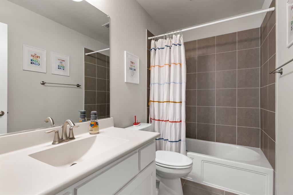 6309 Hall Road Frisco, TX 75034 - Photo 23 of 35 Full bath with shower / bath combo, vanity, and dark tile patterned floors