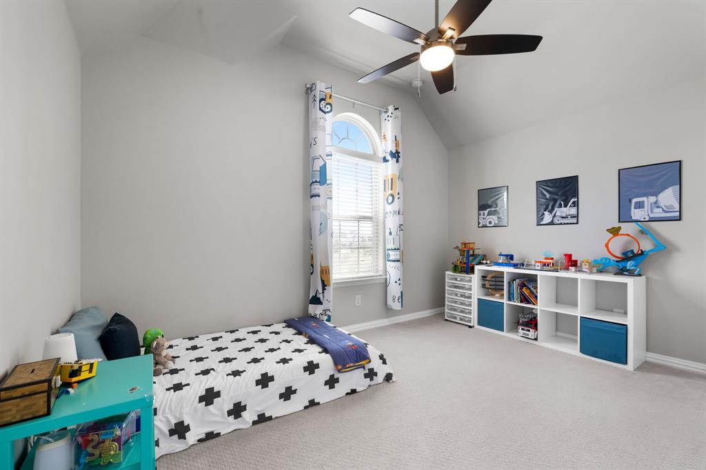6309 Hall Road Frisco, TX 75034 - Photo 25 of 35 Carpeted bedroom featuring vaulted ceiling and ceiling fan