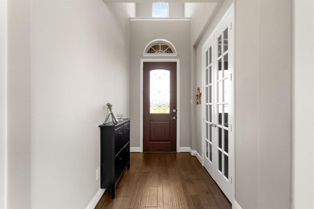 6309 Hall Road Frisco, TX 75034 - Photo 3 of 35 Doorway with healthy amount of natural light, wood finished floors, french doors, and a towering ceiling