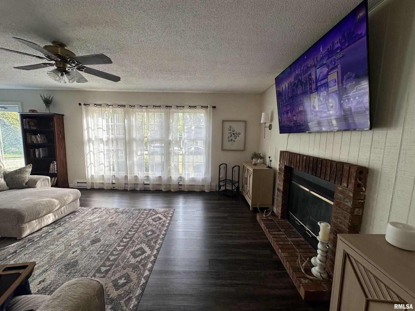 1307 Charles Street Carterville, IL 62918 - Photo 11 of 21 a living room with furniture and a fireplace
