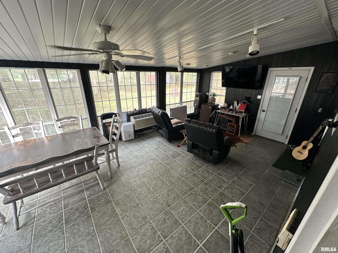 1307 Charles Street Carterville, IL 62918 - Photo 21 of 21 a living room with furniture a flat screen tv and floor to ceiling window