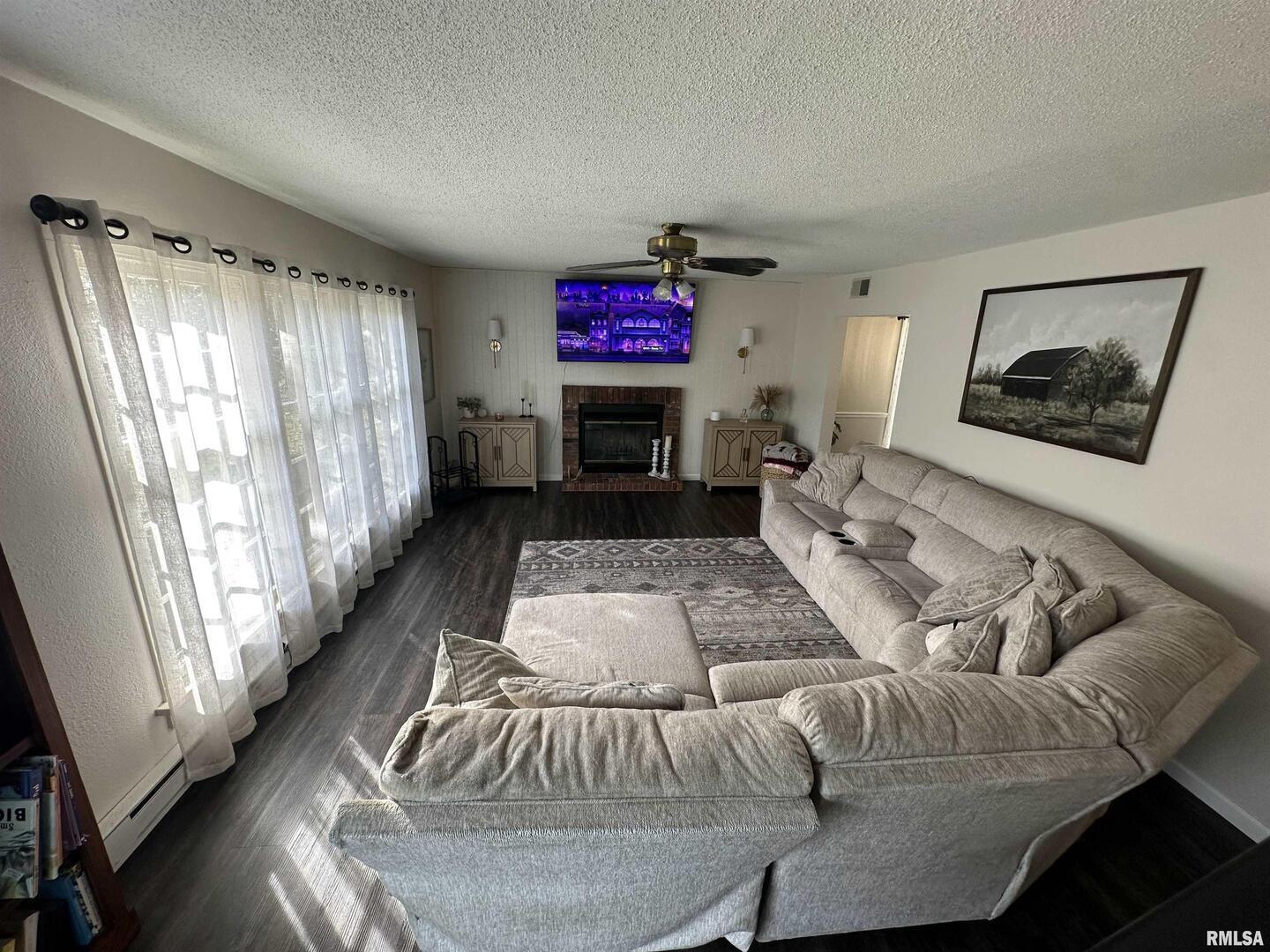 1307 Charles Street Carterville, IL 62918 - Photo 5 of 21 a living room with furniture and a fireplace