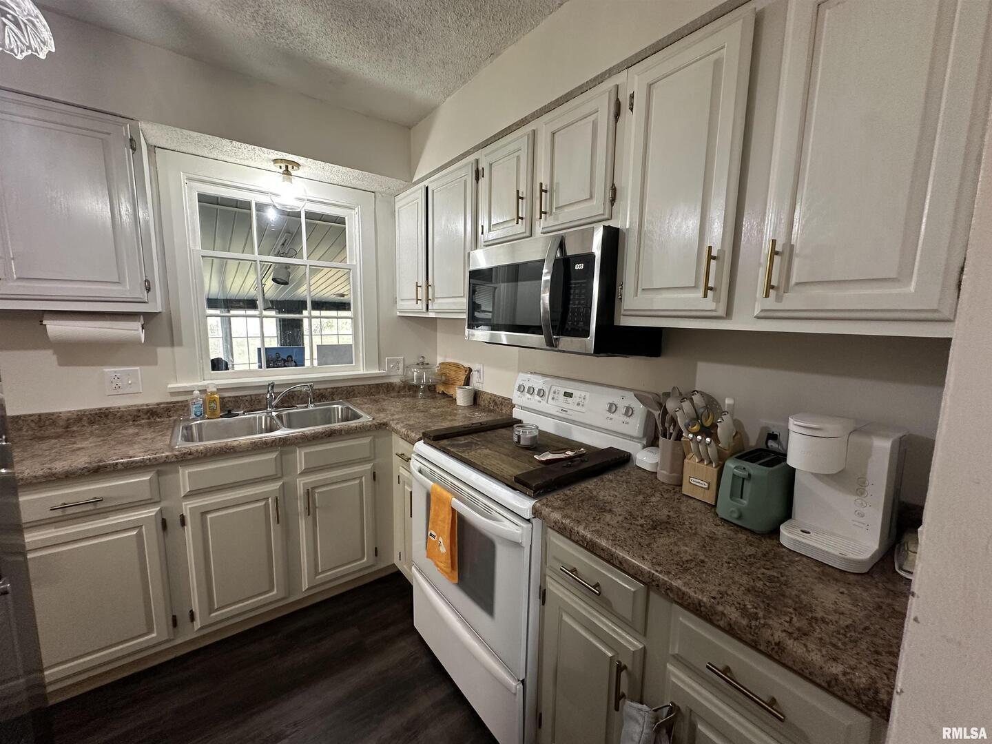 1307 Charles Street Carterville, IL 62918 - Photo 9 of 21 a kitchen with stainless steel appliances granite countertop a sink stove and cabinets