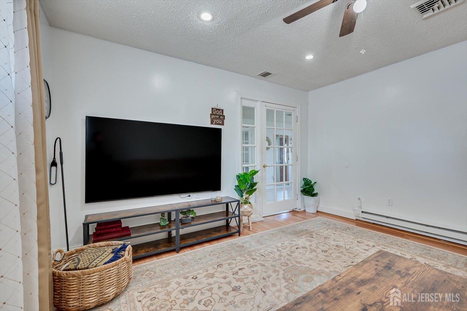 15 Markham Road Edison, NJ 08817 - Photo 18 of 32 a living room with furniture and a flat screen tv