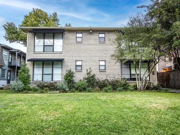 a brick building with a yard