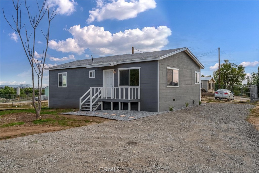22832 Old Elsinore Road Perris, CA 92570 - Photo 1 of 1 a view of a house with backyard and a tree