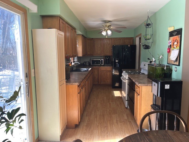 24314 South Burr Road Channahon, IL 60410 - Photo 9 of 17 a kitchen with stainless steel appliances granite countertop a refrigerator a stove a sink dishwasher and a dining table with wooden floor