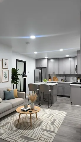 a living room with lots of furniture and kitchen view