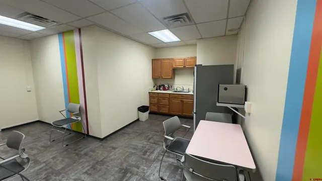 a kitchen with a refrigerator a sink and cabinets