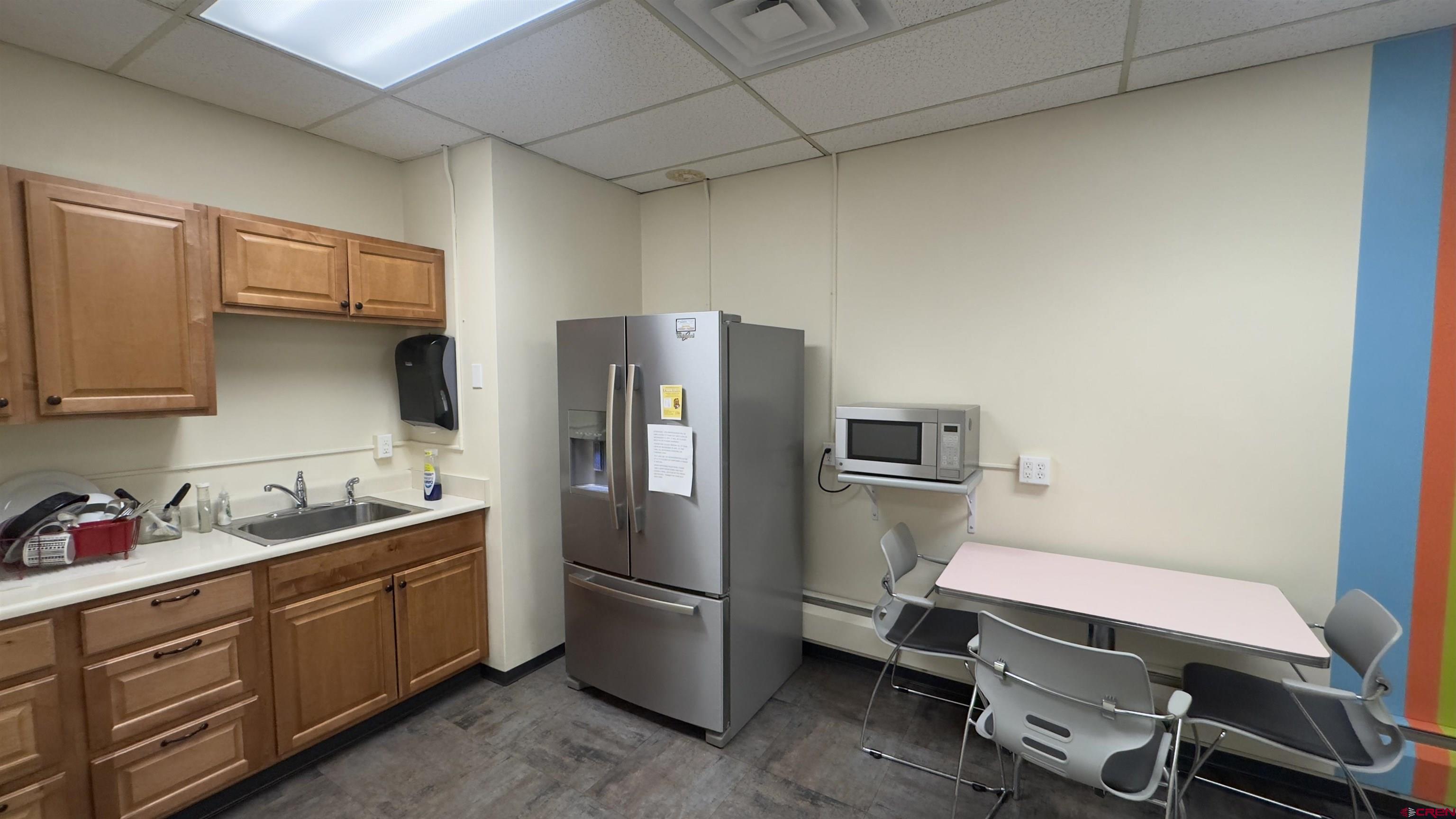 835 East 2nd Avenue, Unit 323 Durango, CO 81301 - Photo 15 of 23 a kitchen with a refrigerator a sink and cabinets