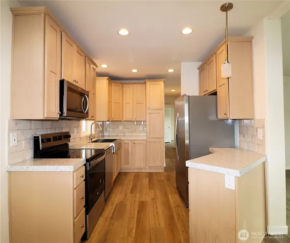 a kitchen with a sink stove and microwave