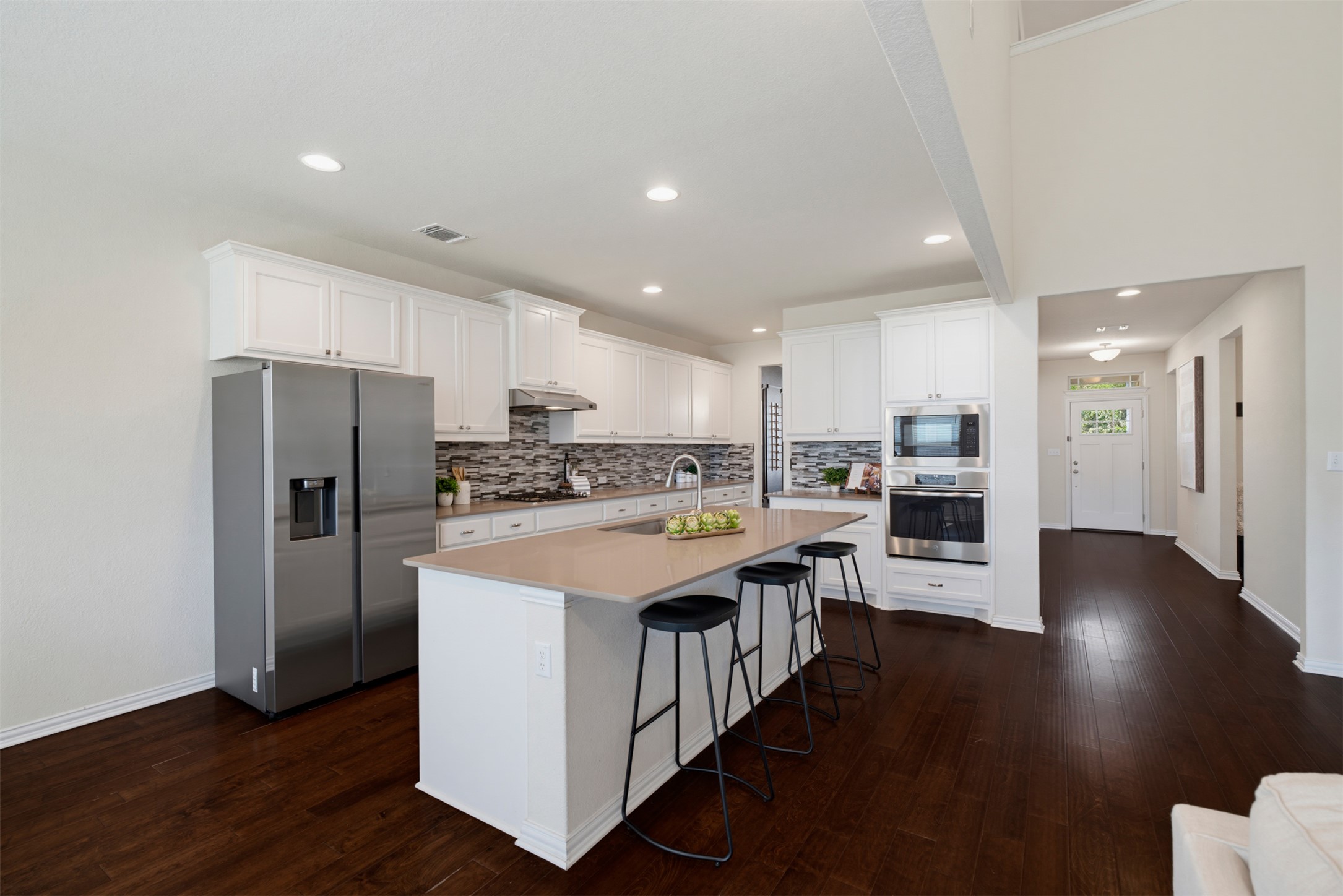 12613 Twisted Root Drive Manchaca, TX 78652 - Photo 5 of 33 Culinary dreams come alive in this kitchen, featuring an island and premium stainless steel appliances.