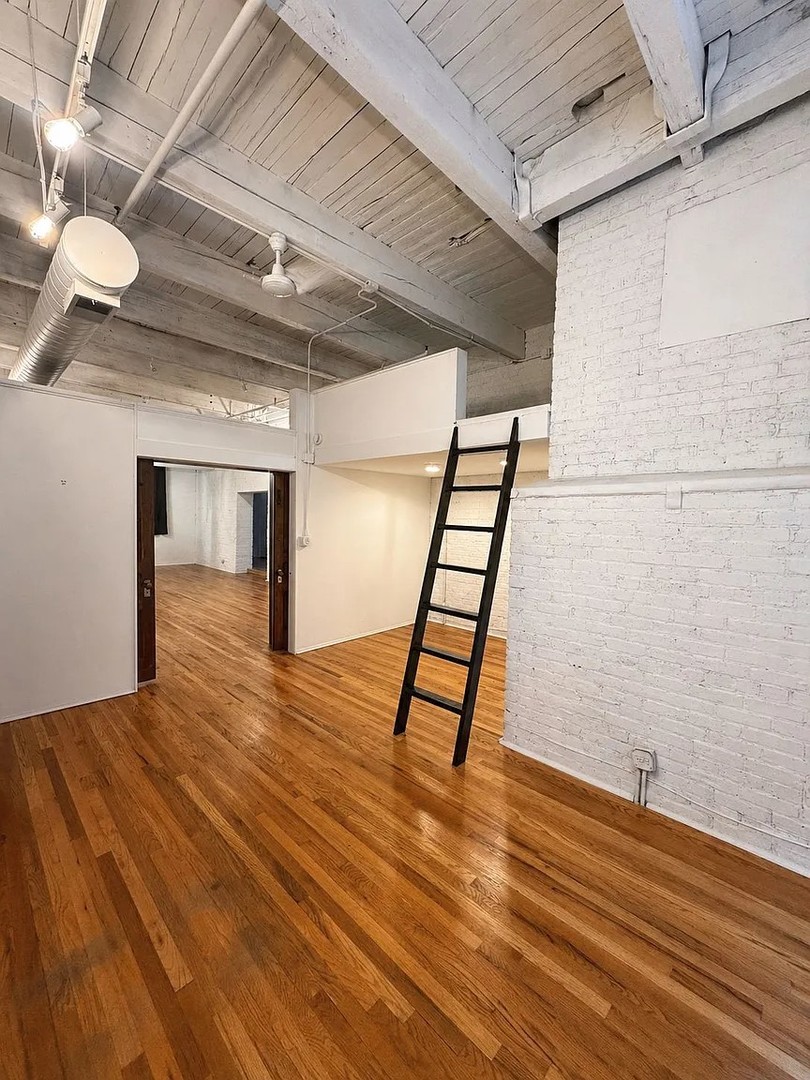 312 North May Street, Unit 4H Chicago, IL 60607 - Photo 4 of 13 a view of empty room with wooden floor