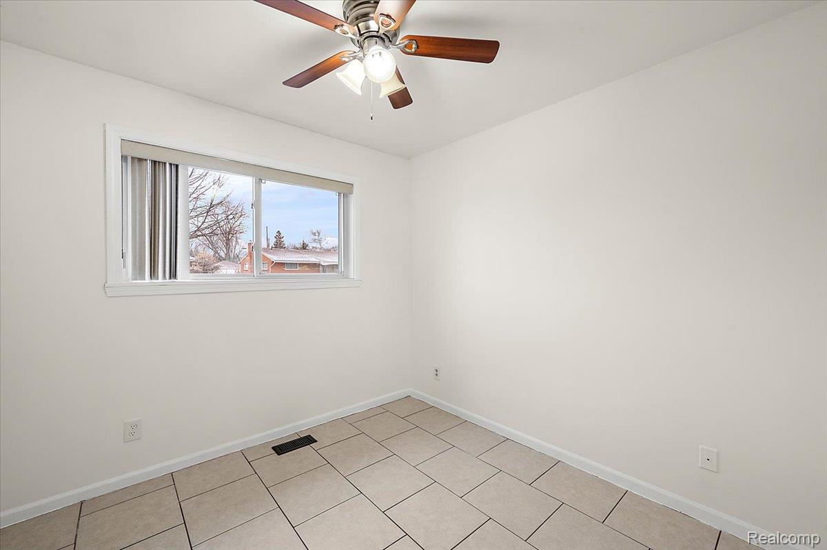 32416 Exeter Drive Warren, MI 48092 - Photo 19 of 33 Empty room featuring baseboards and ceiling fan