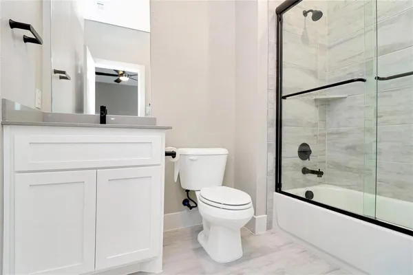 a bathroom with a shower toilet and a sink