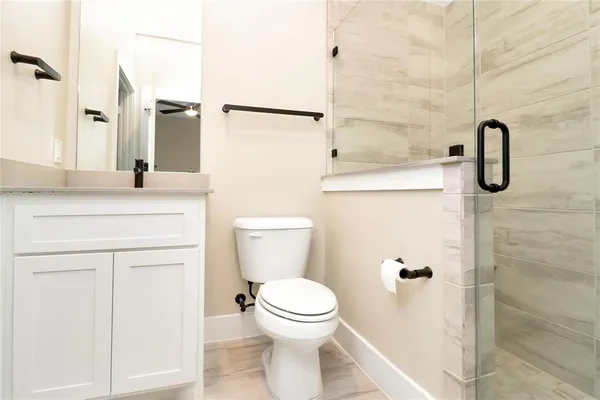 a bathroom with a sink toilet and shower
