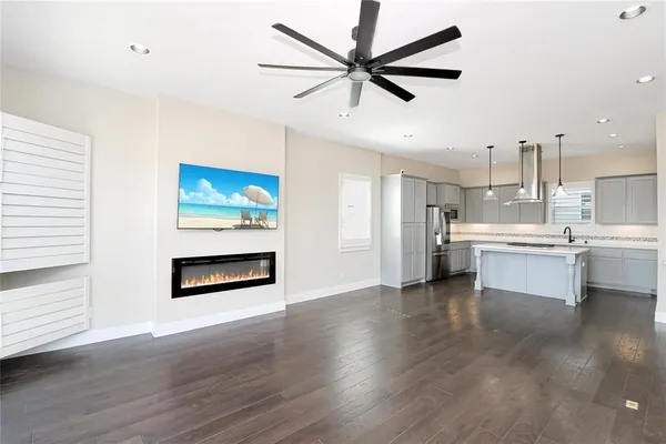 a open kitchen with stainless steel appliances kitchen island a sink and a refrigerator
