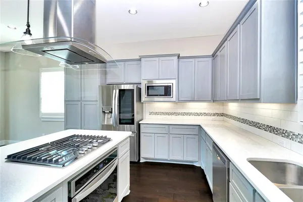 a kitchen with a sink stove and cabinets