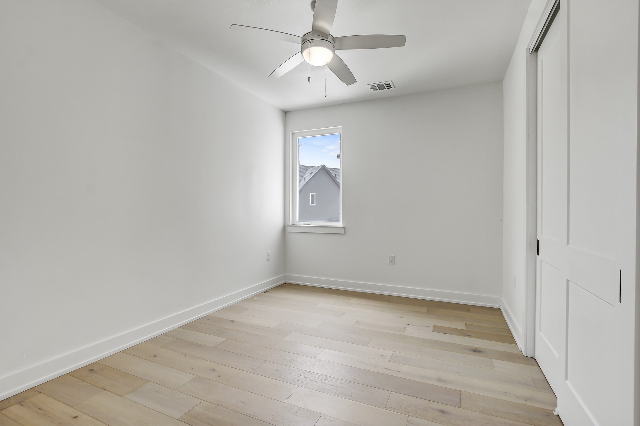 4127 East 12th Street, Unit 3 Austin, TX 78721 - Photo 20 of 29 Unfurnished bedroom featuring baseboards, light wood-style floors, a closet, and a ceiling fan