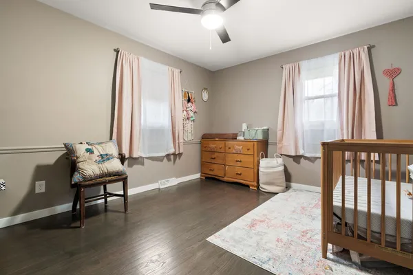 a living room with furniture and two windows