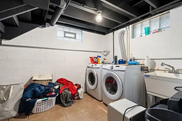 a utility room with dryer washer and a view of living room