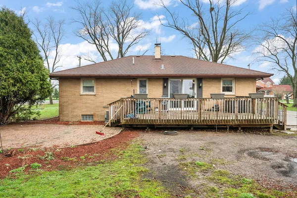 a view of a house with backyard and sitting area