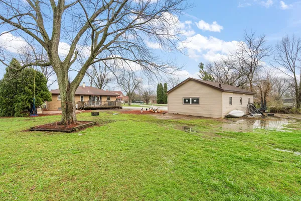 a view of a house with a yard and wooden fence