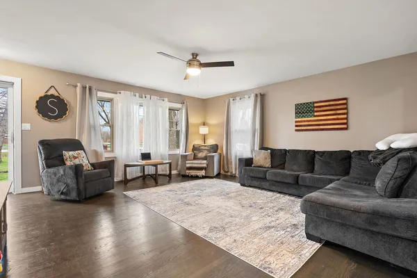 a living room with furniture and a wooden floor