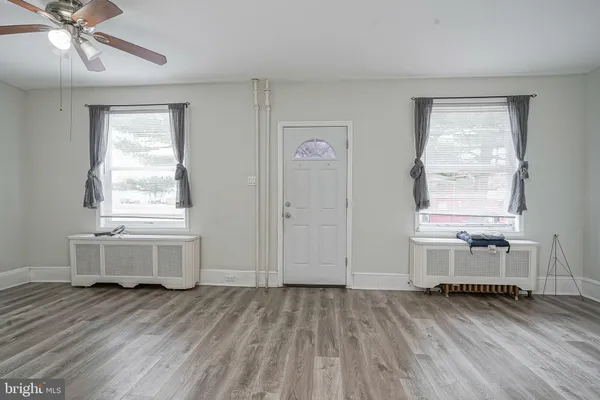 a view of a room with wooden floor and window