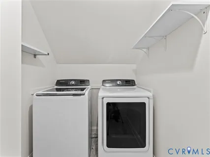 an empty room with windows closet and fan