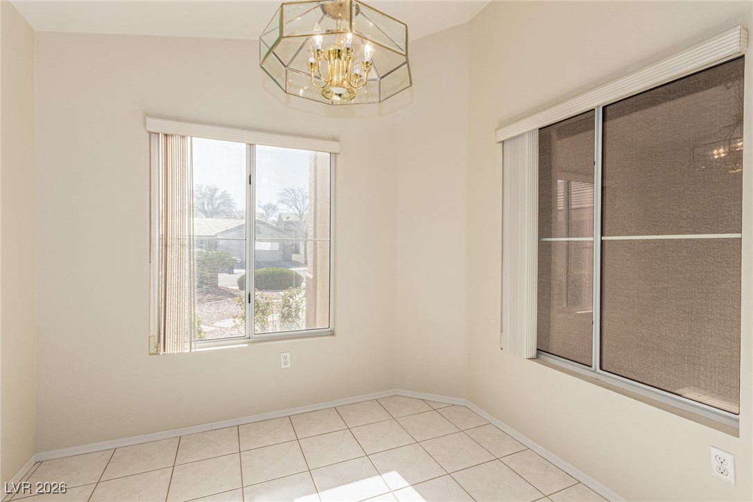 2148 Point Mallard Drive Henderson, NV 89012 - Photo 13 of 31 Unfurnished dining area featuring a chandelier and light tile patterned floors