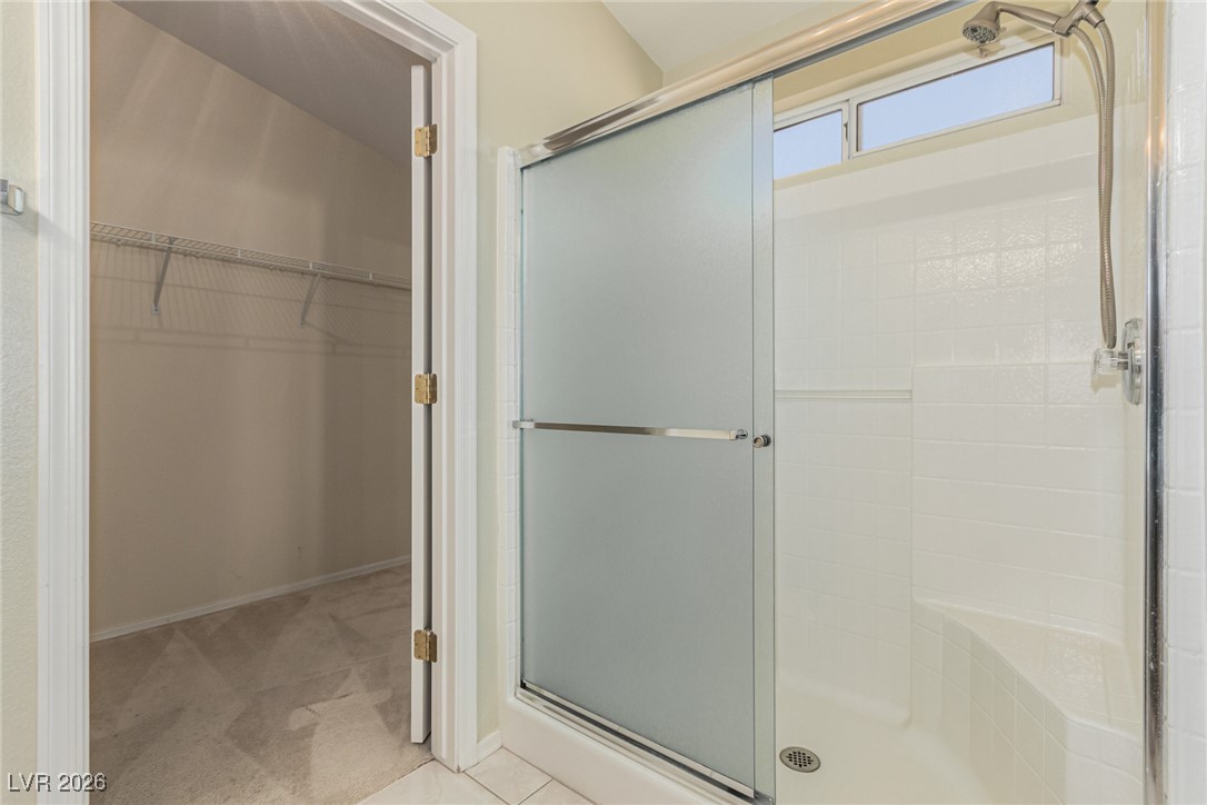 2148 Point Mallard Drive Henderson, NV 89012 - Photo 18 of 31 Full bath with a spacious closet, light carpet, and a stall shower