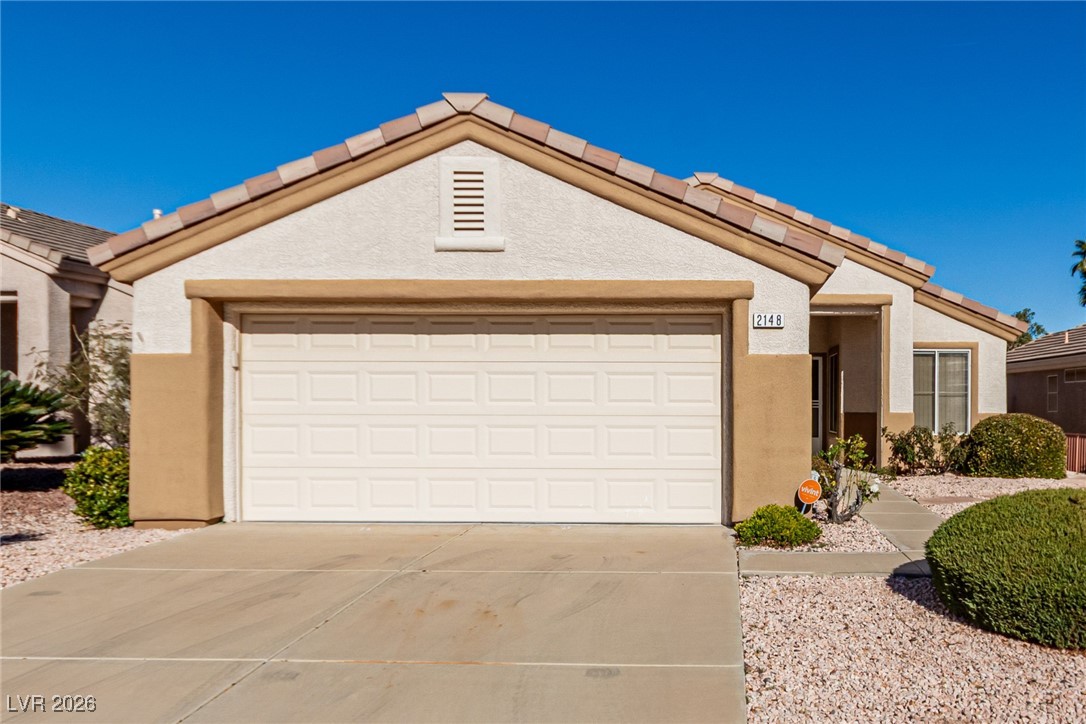 2148 Point Mallard Drive Henderson, NV 89012 - Photo 29 of 31 Single story home with a tile roof, driveway, stucco siding, and an attached garage