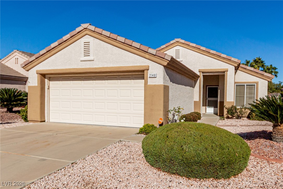2148 Point Mallard Drive Henderson, NV 89012 - Photo 30 of 31 View of front facade featuring concrete driveway, stucco siding, a tiled roof, and a garage
