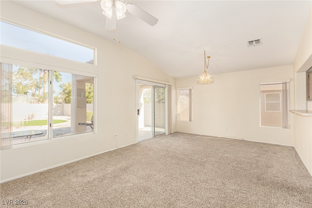 2148 Point Mallard Drive Henderson, NV 89012 - Photo 5 of 31 Unfurnished room featuring carpet floors, a chandelier, vaulted ceiling, and a ceiling fan