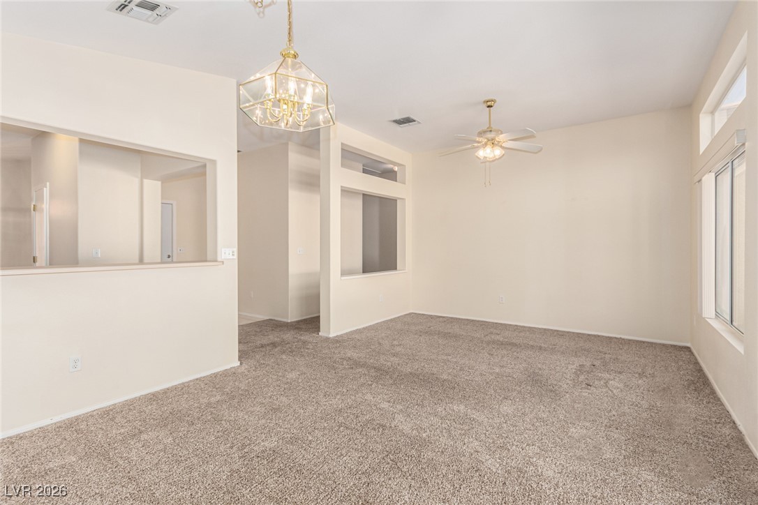 2148 Point Mallard Drive Henderson, NV 89012 - Photo 6 of 31 Spare room with carpet floors, a chandelier, and ceiling fan